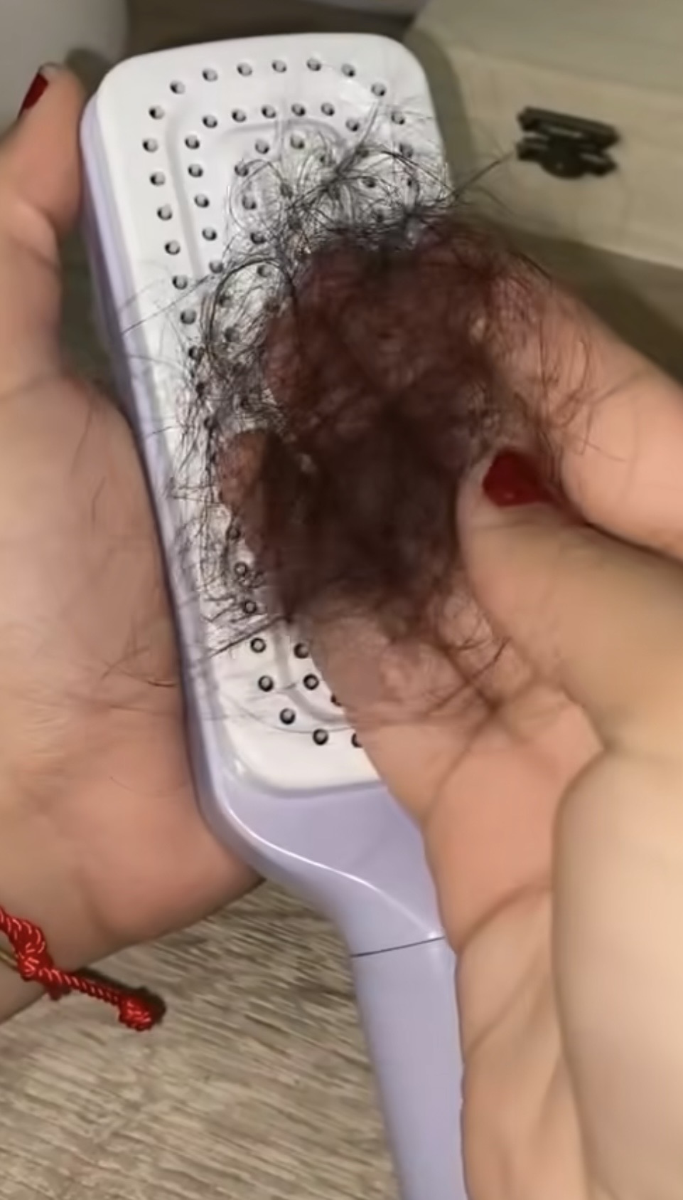 Close up of a hairbrush matted with shed hair and scalp buildup