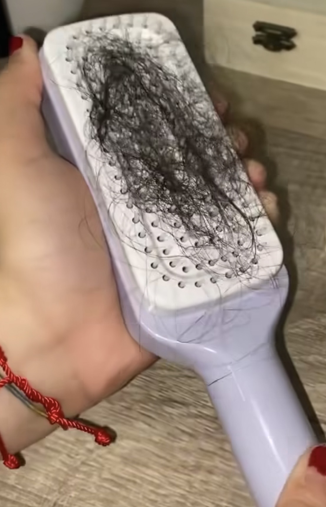 A dirty hairbrush packed with hair, dead skin and gunk